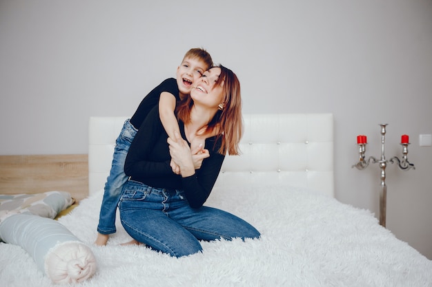 Beautiful mother with cute son at home