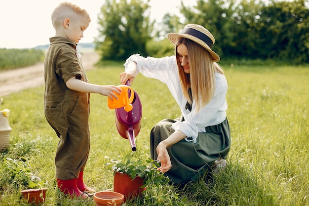 Free photo beautiful mother with little son in a summer field