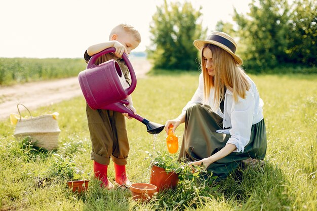 Beautiful mother with little son in a summer field