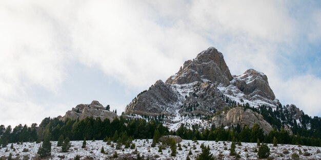 Beautiful mountain range covered with snow enveloped in fog - great for a natural