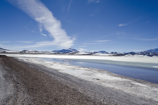 Beautiful mountainous landscape partially covered with snow under a bright sky in Argentina