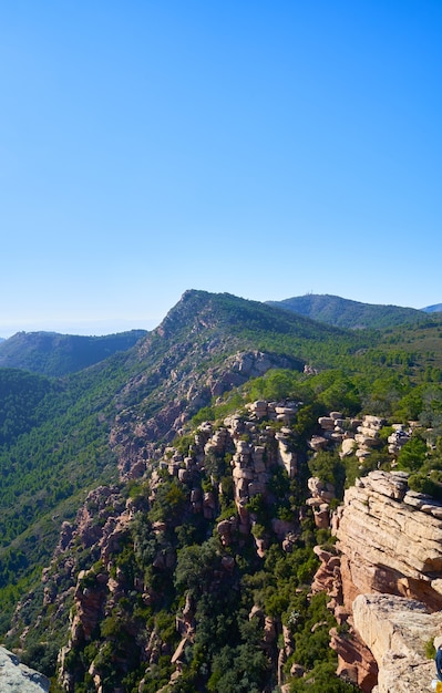 Beautiful natural landscape with rocky cliffs surrounded by greenery under a bright sky