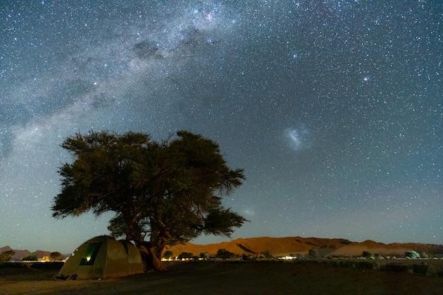 Free Photo beautiful night landscape view of milky way and galactic core over etosha national park camping, namibia