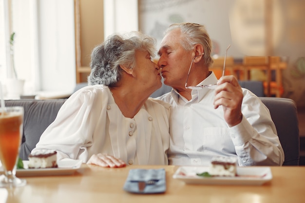 Beautiful old couple sitting in a cafe