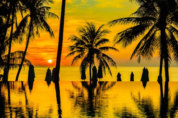 Free Photo beautiful outdoor nature landscape with sea ocean and coconut palm tree around swimming pool at sunrsie or sunset