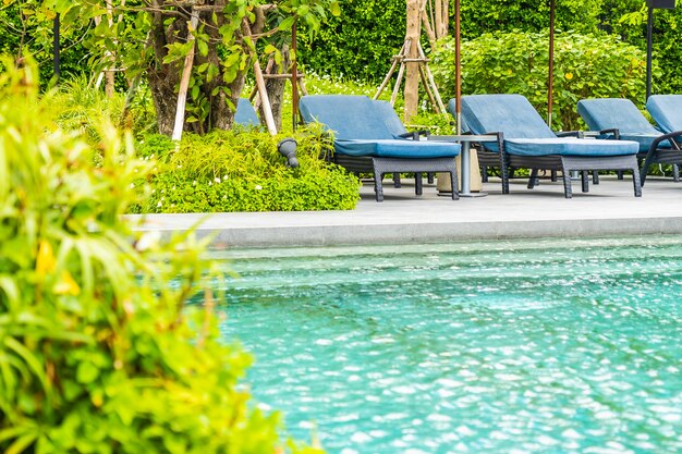 Beautiful outdoor swimming pool in hotel and resort with chair and deck for leisure vacation