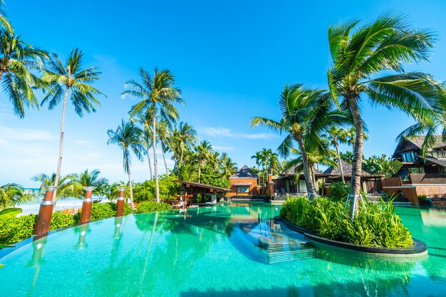 Beautiful outdoor swimming pool with coconut palm tree