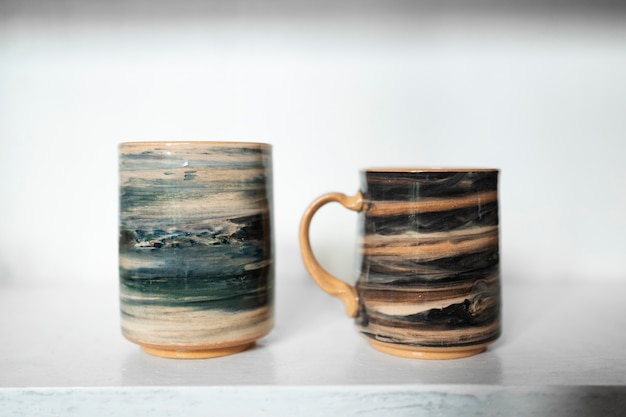 Free Photo beautiful painted mugs arrangement