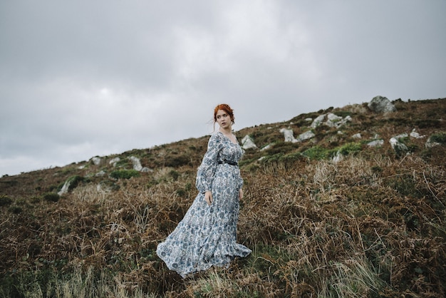 Free photo beautiful picture of a ginger female with a pure white skin in an attractive light blue gown