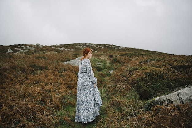 Free Photo beautiful picture of a ginger female with a pure white skin in an attractive light blue gown