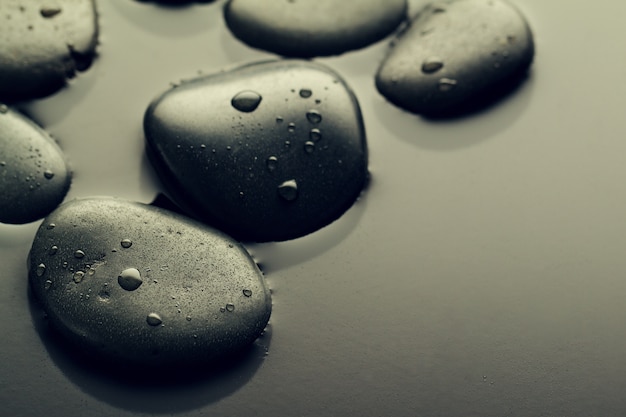 Free photo beautiful picture of spa hot stones, view from above. dark background. top. spa concept. side composition.