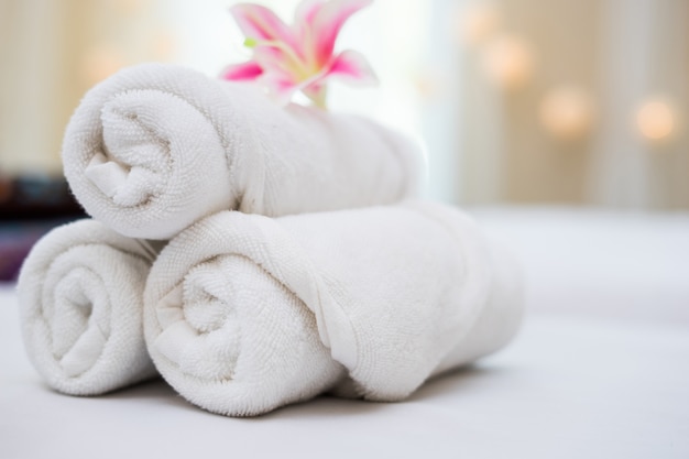 beautiful pink orchid on white towel in spa salon.