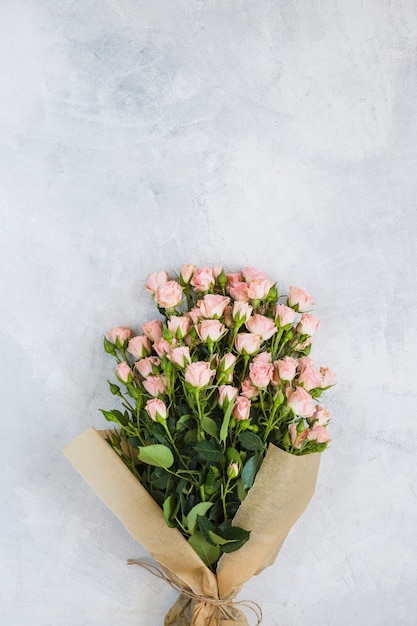 Beautiful pink roses bouquet on concrete background