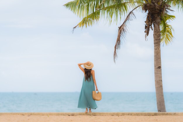 Beautiful portrait young asian women happy smile relax around beach sea ocean