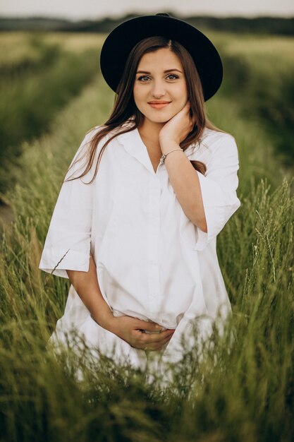 Beautiful pregnant woman in a field