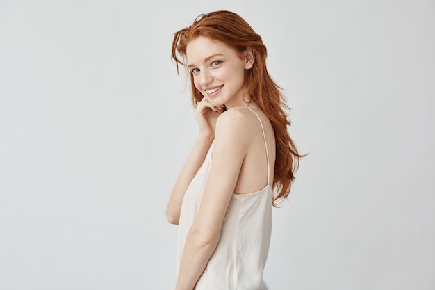 Beautiful redhead girl with freckles smiling 