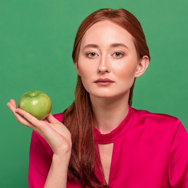 Free Photo beautiful redhead woman portrait with vegetable