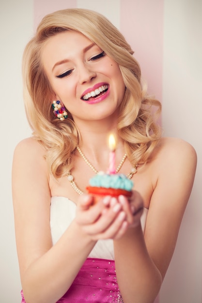 Beautiful retro woman celebrate with blue muffin