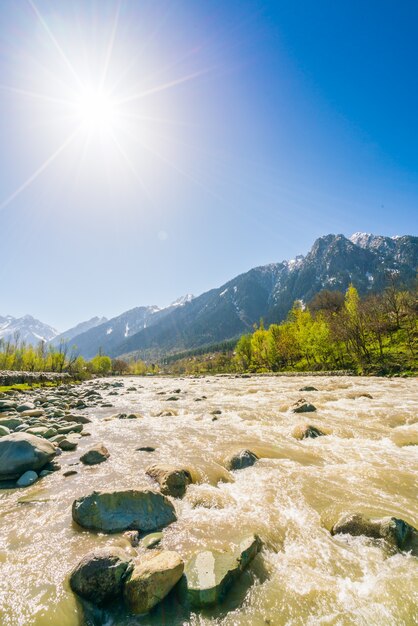 Beautiful  River and snow covered mountains landscape Kashmir state, India .