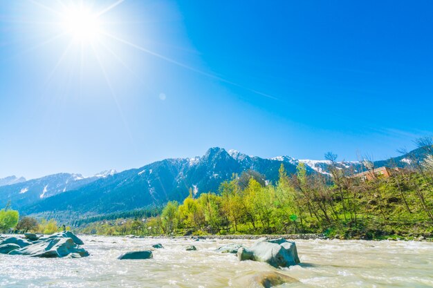 Beautiful  River and snow covered mountains landscape Kashmir state, India .