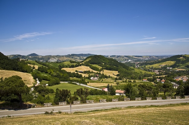 Beautiful road along the rural houses with a mountainous landscape