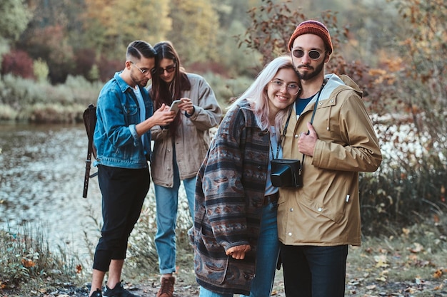 Free photo beautiful romantic couples of young people are enjoying their walk in the autumn park.