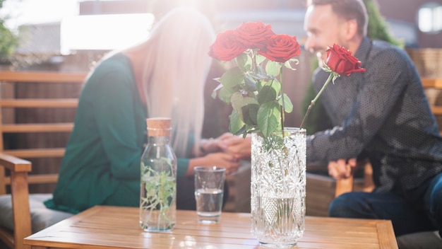 Beautiful roses in front of couple dating together