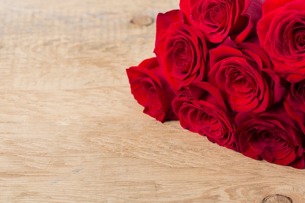 Beautiful roses on wooden table