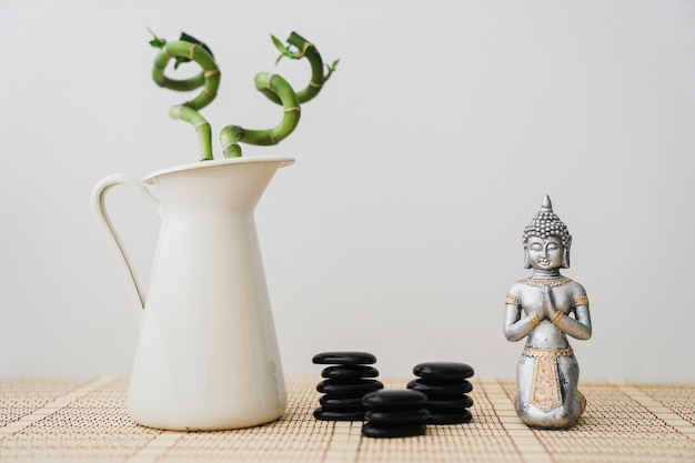 Free Photo beautiful scene with volcanic stones, buddha and bamboo