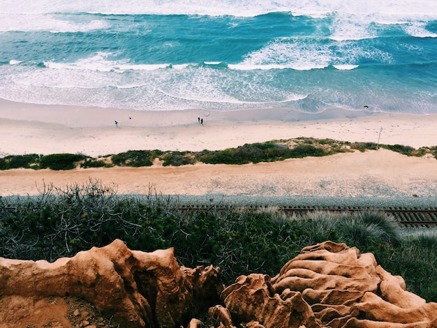 Beautiful scenery of the beach with few people shot from a higher ground