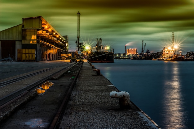 Free Photo beautiful scenery of buildings with lights near the lake under the breathtaking sky