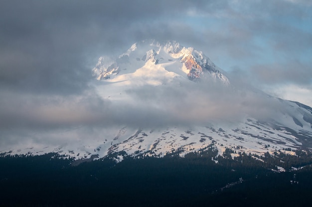 Beautiful scenery of clouds covering the mount Hood