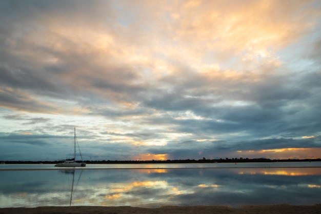 Beautiful scenery of colorful clouds reflecting  in the sea during sunset