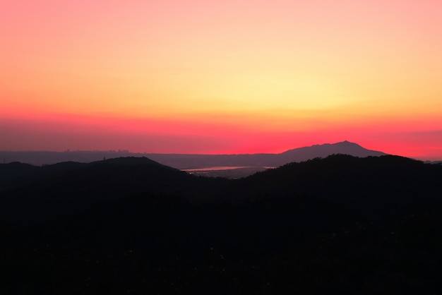 Beautiful scenery of high grassy hills under the breathtaking sunset sky