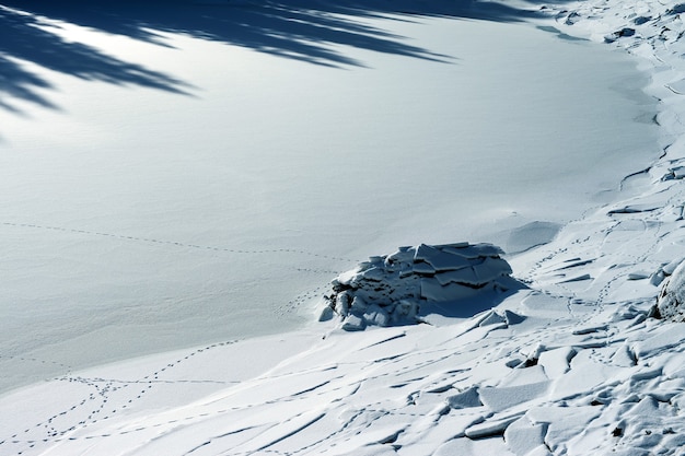 Beautiful scenery of land covered with snow with cracks in the Dolomites