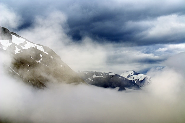 Free Photo beautiful scenery of a mountain range covered with snow under white clouds in norway