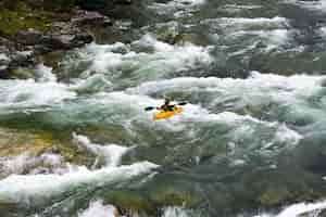 Free photo beautiful scenery of the rafting on the mountain river stream flowing down between huge stones