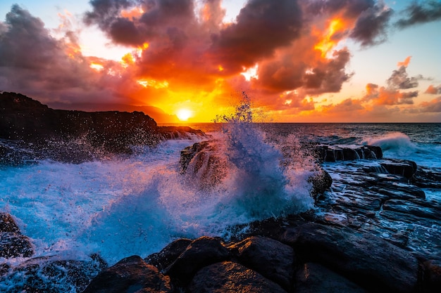 Beautiful scenery of rock formations by the sea at Queens Bath, Kauai, Hawaii at sunset