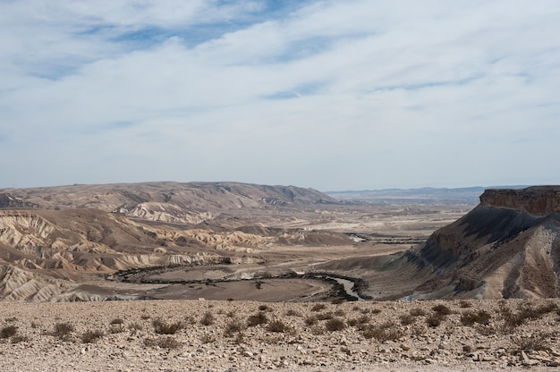 Free photo beautiful scenery of a rocky landscape under a cloudy and blue sky