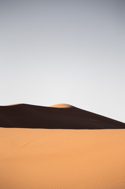 Beautiful scenery of sand dunes in a desert area on a sunny day