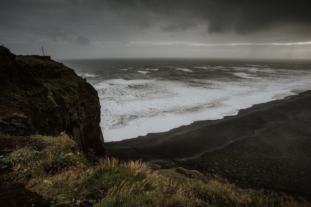 Free Photo beautiful scenery of the sea surrounded by rock formations enveloped in fog in iceland