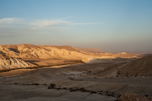 Beautiful scenery of a shadowed landscape under a sunny and blue sky