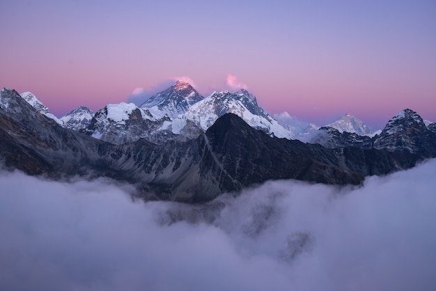 Free photo beautiful scenery of the summit of mount everest covered with snow under the white clouds