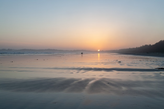 Free Photo beautiful scenery of sunset at the beach of the pacific rim national park on vancouver island canada