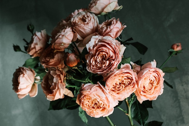 Beautiful selective closeup shot of pink garden roses in a glass vase