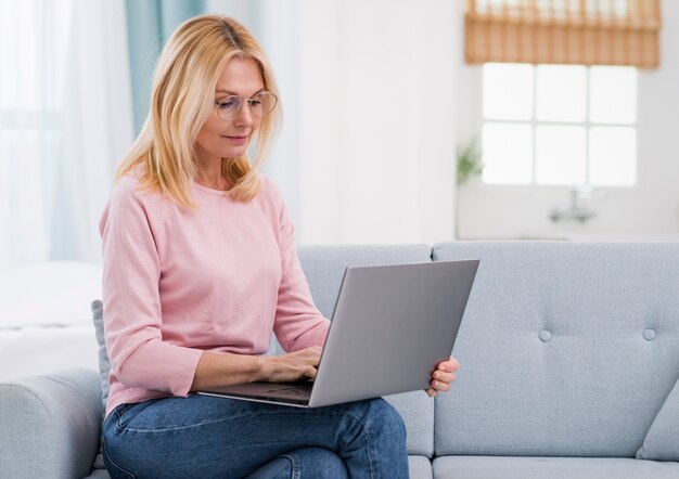 Beautiful senior woman holding a laptop