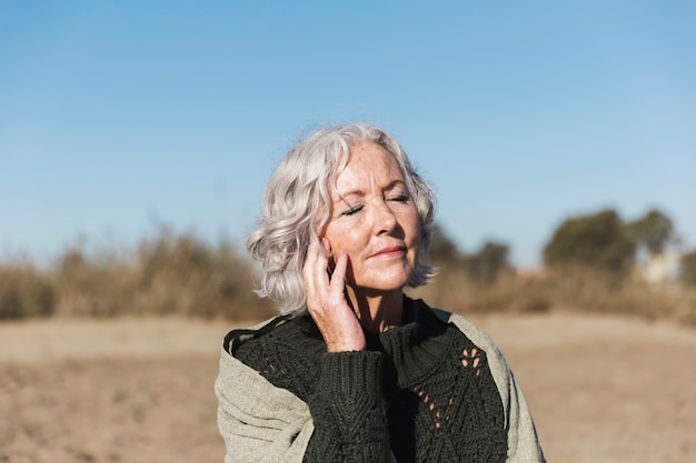 Beautiful senior woman relaxing outdoors