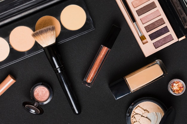 Free photo beautiful set of professional makeup cosmetics on dark table