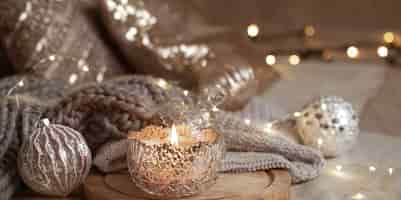 Free photo beautiful shiny silver christmas decor and burning candle close up. cozy winter atmosphere.