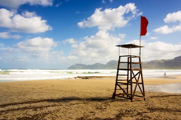 Free photo beautiful shot of a beach lifeguard seat with a red flag in mallorca